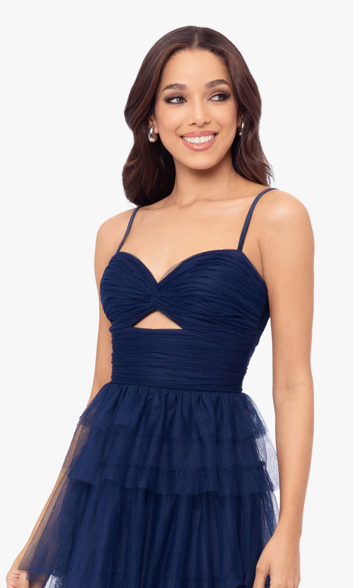 A woman models the Cut-Out Short Ruffled Homecoming Dress 5098BN—navy blue, sleeveless, with thin straps, a ruched sweetheart bodice, ruffled A-line skirt, and a small triangular cutout below the bust—against a plain background.